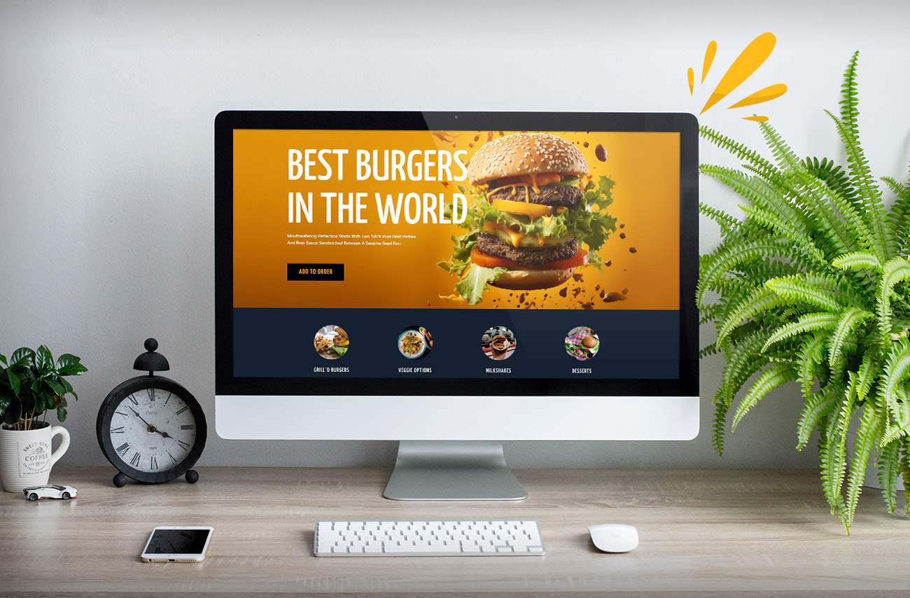 A desktop computer displays a vibrant burger website, promoting the "Best Burgers in the World" with an appealing gourmet burger image.